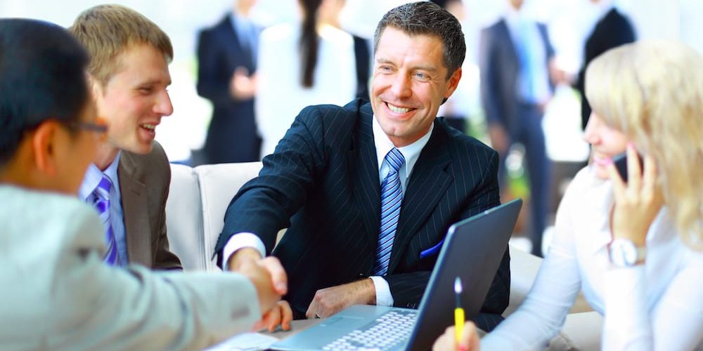 man shaking hands representing insurance bonds